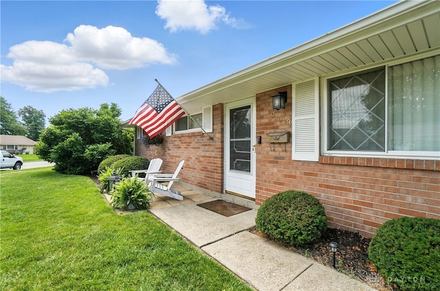 903 Meadow Ln, Lebanon, OH 45036 - view of exterior entry featuring a yard and brick siding