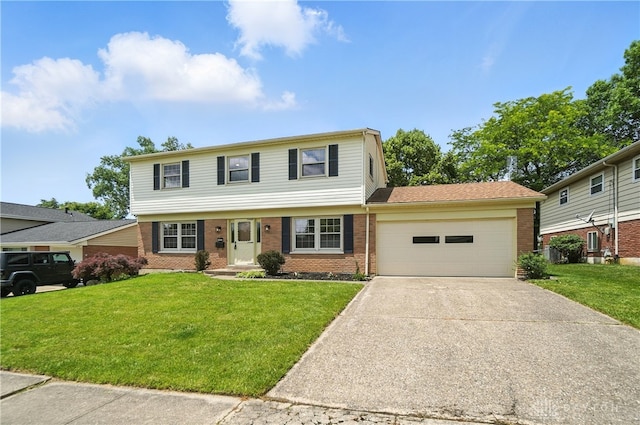 1023 Hilliard Dr, Delhi Twp, OH 45238 - colonial house with brick siding, a garage, driveway, and a front yard