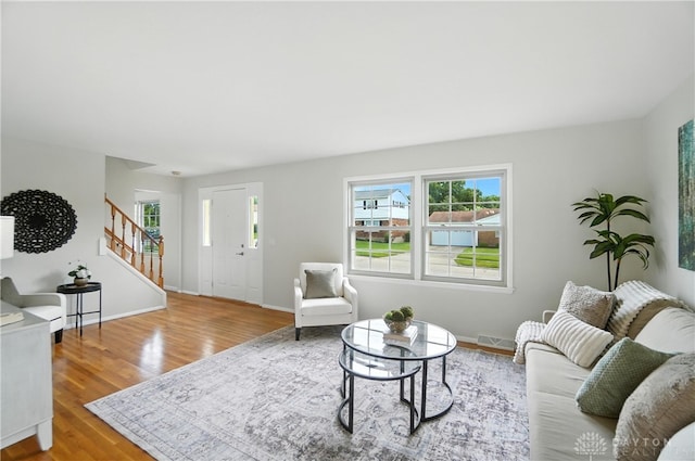 1023 Hilliard Dr, Delhi Twp, OH 45238 - living area with stairs, wood finished floors, and plenty of natural light