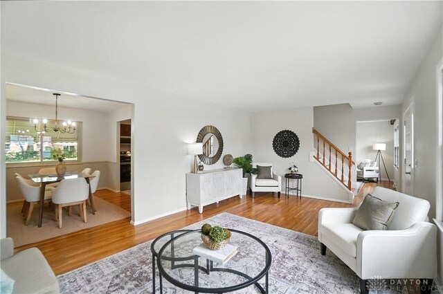 1023 Hilliard Dr, Delhi Twp, OH 45238 - living area with stairs, a chandelier, and wood finished floors