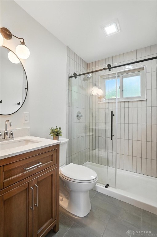 1023 Hilliard Dr, Delhi Twp, OH 45238 - bathroom with tile patterned floors, vanity, and a stall shower