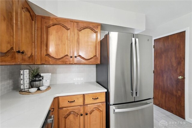 1023 Hilliard Dr, Delhi Twp, OH 45238 - kitchen with freestanding refrigerator, light countertops, and brown cabinetry