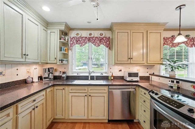 1804 Schirm Dr, Middletown, OH 45042 - kitchen featuring stainless steel appliances, cream cabinets, a ceiling fan, hanging light fixtures, and tasteful backsplash