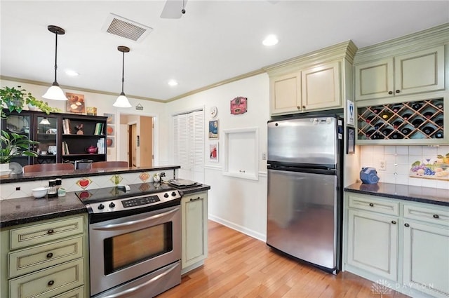 1804 Schirm Dr, Middletown, OH 45042 - kitchen with appliances with stainless steel finishes, tasteful backsplash, green cabinets, light wood finished floors, and recessed lighting