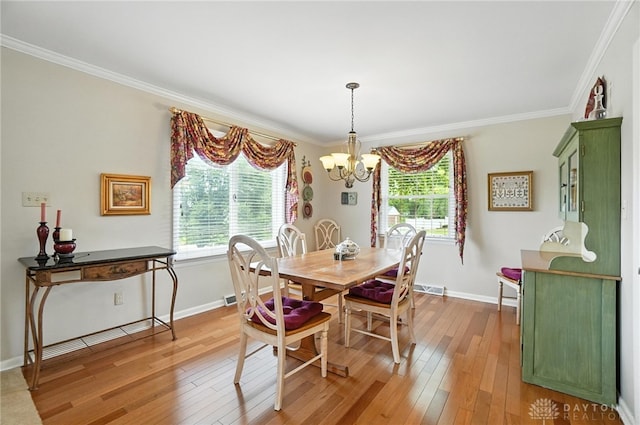 1804 Schirm Dr, Middletown, OH 45042 - dining room with a chandelier, wood-type flooring, healthy amount of natural light, and crown molding