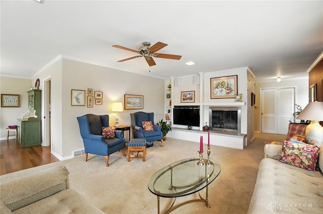 1804 Schirm Dr, Middletown, OH 45042 - carpeted living room featuring ornamental molding, ceiling fan, and a fireplace