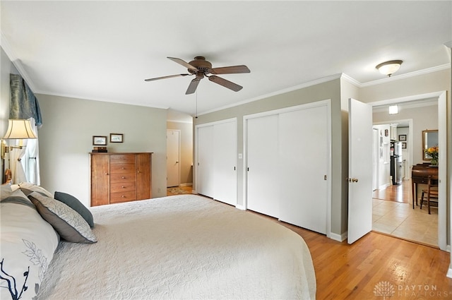 1804 Schirm Dr, Middletown, OH 45042 - bedroom with multiple closets, light wood-style floors, crown molding, and a ceiling fan