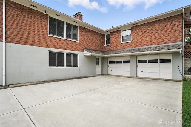 1804 Schirm Dr, Middletown, OH 45042 - view of front of property with driveway, a garage, a chimney, and brick siding