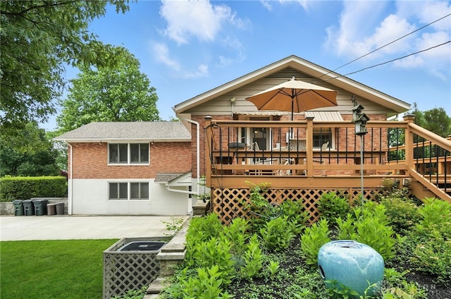 1804 Schirm Dr, Middletown, OH 45042 - rear view of house featuring brick siding, a deck, a patio, and a lawn