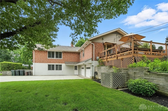 1804 Schirm Dr, Middletown, OH 45042 - back of property with a garage, a yard, brick siding, a wooden deck, and a patio
