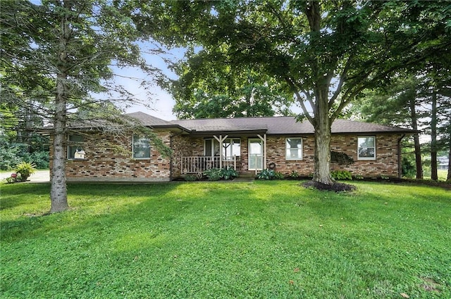 8425 Dillman Rd, Camden, OH 45311 - single story home featuring a porch, brick siding, and a front lawn