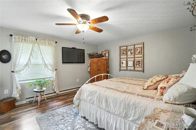 8425 Dillman Rd, Camden, OH 45311 - bedroom featuring baseboard heating, wood finished floors, and ceiling fan