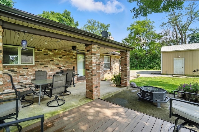 8425 Dillman Rd, Camden, OH 45311 - deck featuring a patio area, a ceiling fan, outdoor dining space, a grill, and an outdoor structure