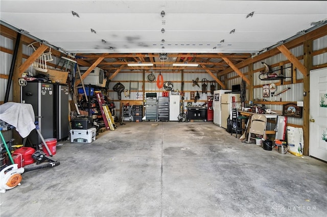 8425 Dillman Rd, Camden, OH 45311 - garage featuring a workshop area and freestanding refrigerator