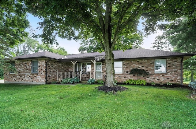 8425 Dillman Rd, Camden, OH 45311 - ranch-style home with covered porch, brick siding, and a front lawn