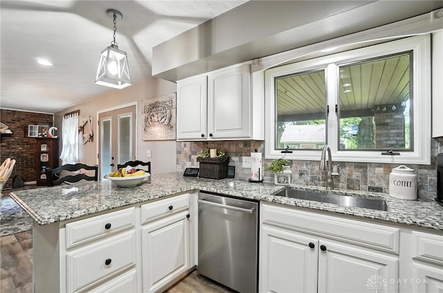 8425 Dillman Rd, Camden, OH 45311 - kitchen featuring dishwasher, a peninsula, decorative backsplash, and white cabinets