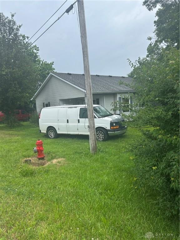3832 E Lower Springboro Rd, Waynesville, OH 45068 - view of side of property with a lawn and roof with shingles