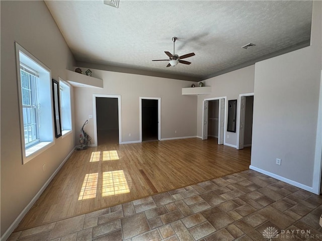 523 Newport Rd, Xenia, OH 45385 - unfurnished living room with a textured ceiling, a ceiling fan, and wood finished floors