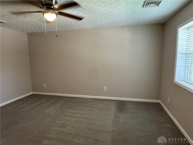 523 Newport Rd, Xenia, OH 45385 - empty room with a textured ceiling, ceiling fan, and dark colored carpet