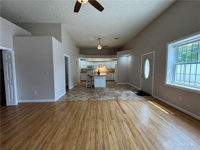 523 Newport Rd, Xenia, OH 45385 - entryway featuring ceiling fan, light wood-style floors, vaulted ceiling, and a textured ceiling