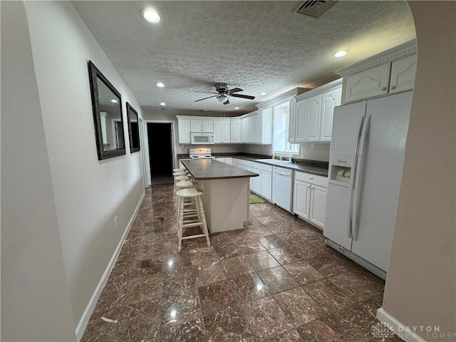 523 Newport Rd, Xenia, OH 45385 - kitchen featuring white appliances, dark countertops, a textured ceiling, a ceiling fan, and recessed lighting