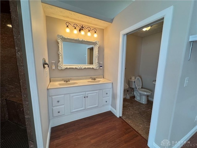 523 Newport Rd, Xenia, OH 45385 - bathroom featuring double vanity, wood finished floors, and a tile shower