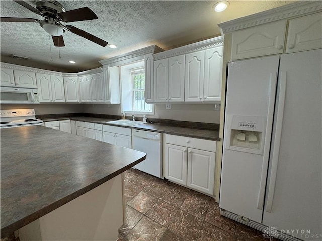 523 Newport Rd, Xenia, OH 45385 - kitchen with white appliances, dark countertops, a textured ceiling, recessed lighting, and white cabinetry