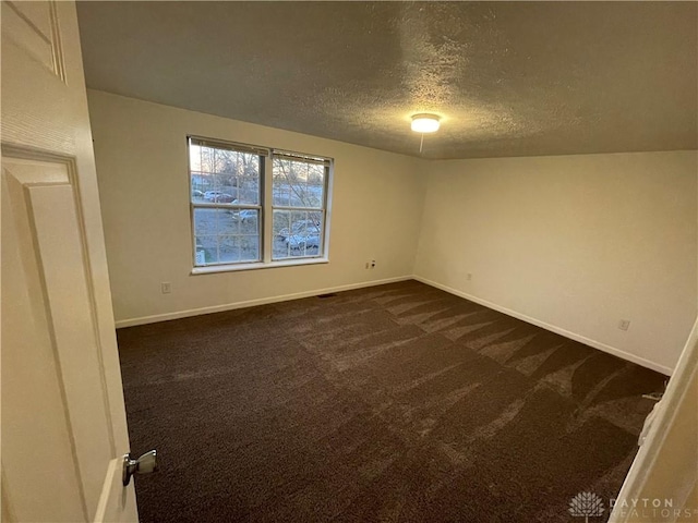 2133 Chapel Dr, Fairborn, OH 45324 - empty room featuring a textured ceiling and dark carpet