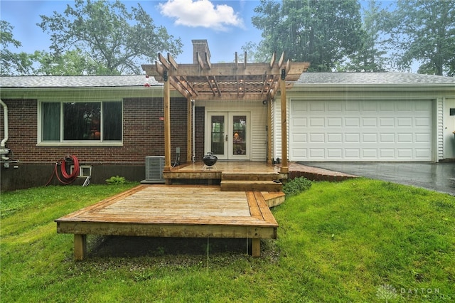 945 Oakland Dr, Beavercreek Twp, OH 45434 - view of front of home with french doors, a front yard, asphalt driveway, a pergola, and a wooden deck