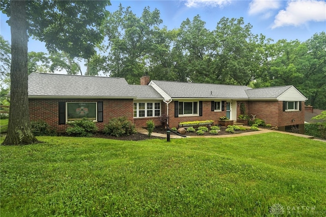 945 Oakland Dr, Beavercreek Twp, OH 45434 - ranch-style house featuring brick siding, a front lawn, a chimney, and a shingled roof