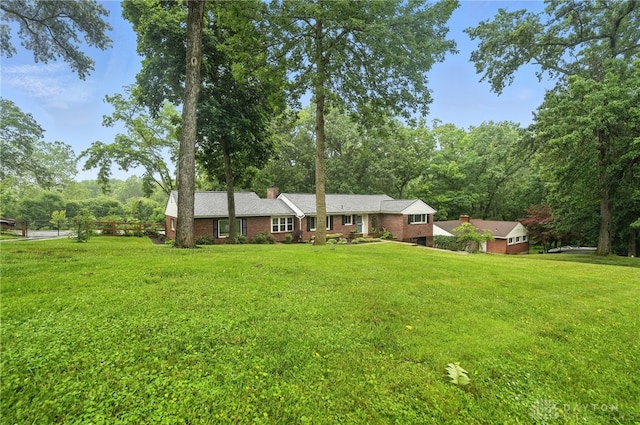 945 Oakland Dr, Beavercreek Twp, OH 45434 - view of front of home featuring a chimney, a front yard, and brick siding