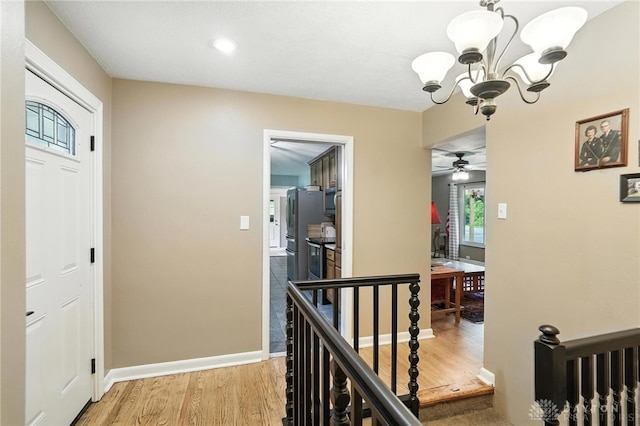 945 Oakland Dr, Beavercreek Twp, OH 45434 - corridor featuring an upstairs landing, light wood finished floors, and a chandelier