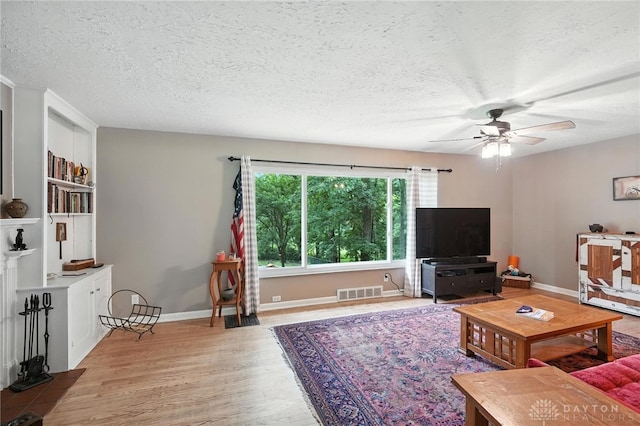 945 Oakland Dr, Beavercreek Twp, OH 45434 - living area with a textured ceiling, wood finished floors, and ceiling fan