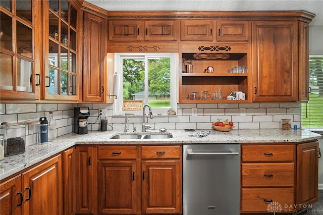 945 Oakland Dr, Beavercreek Twp, OH 45434 - kitchen featuring stainless steel dishwasher, decorative backsplash, light stone countertops, and brown cabinets