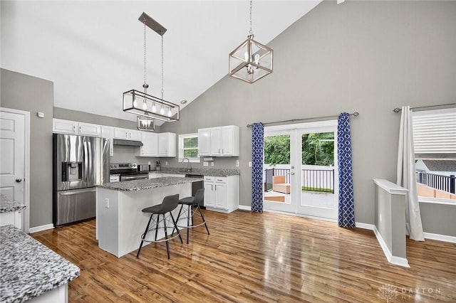 2858 Willow Ridge Dr, Colerain Twp, OH 45251 - kitchen with appliances with stainless steel finishes, high vaulted ceiling, a chandelier, white cabinets, and a center island