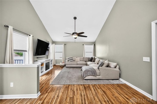 2858 Willow Ridge Dr, Colerain Twp, OH 45251 - living room with ceiling fan, wood finished floors, high vaulted ceiling, and a glass covered fireplace