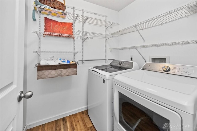 2858 Willow Ridge Dr, Colerain Twp, OH 45251 - laundry room with washing machine and clothes dryer and wood finished floors