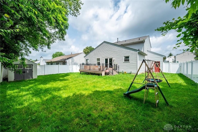 2858 Willow Ridge Dr, Colerain Twp, OH 45251 - back of property featuring a playground, a wooden deck, a storage shed, and a fenced backyard