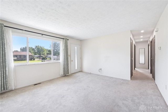 1513 Arrowhead Trl, Xenia, OH 45385 - carpeted empty room featuring a textured ceiling
