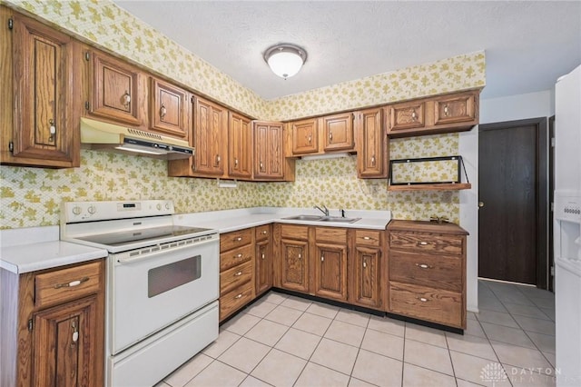1513 Arrowhead Trl, Xenia, OH 45385 - kitchen featuring white range with electric stovetop, under cabinet range hood, wallpapered walls, brown cabinetry, and light countertops