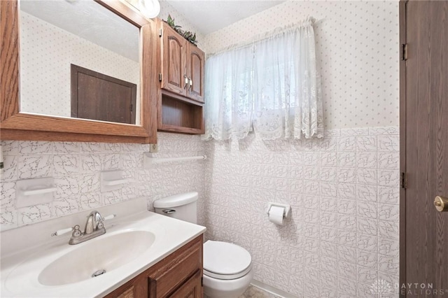 1513 Arrowhead Trl, Xenia, OH 45385 - bathroom featuring vanity, wallpapered walls, and tile walls