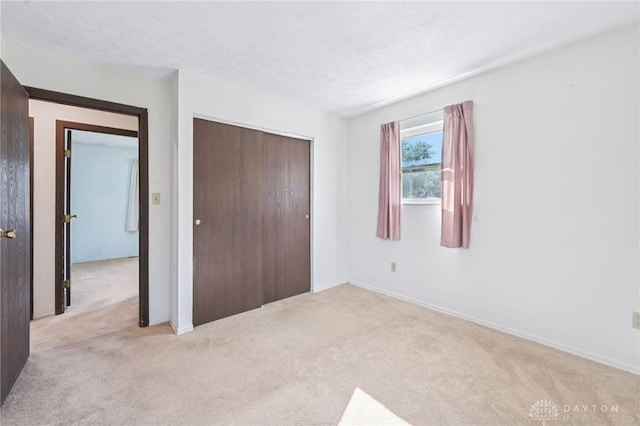 1513 Arrowhead Trl, Xenia, OH 45385 - unfurnished bedroom with carpet, a closet, and a textured ceiling