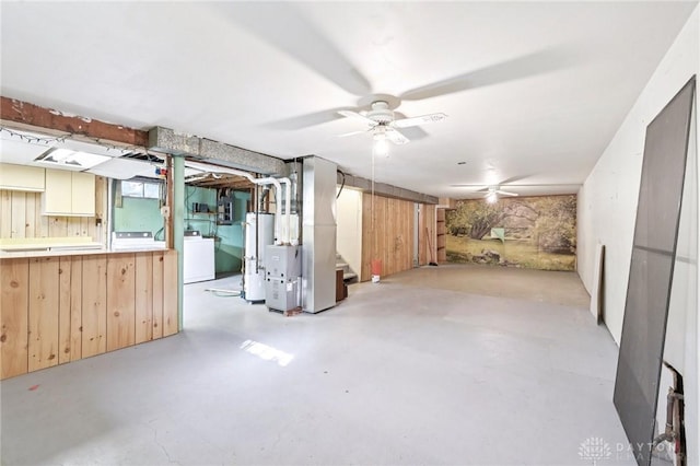 1513 Arrowhead Trl, Xenia, OH 45385 - basement featuring washer / dryer, gas water heater, ceiling fan, wooden walls, and stairs