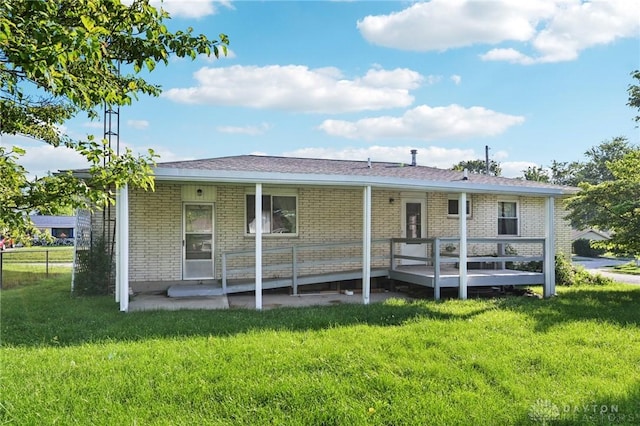 1513 Arrowhead Trl, Xenia, OH 45385 - rear view of property with brick siding, a lawn, a patio area, and a wooden deck
