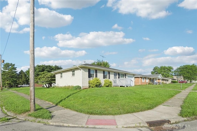 1513 Arrowhead Trl, Xenia, OH 45385 - view of front facade with a front yard, brick siding, and a wooden deck