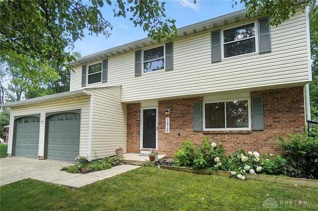 1424 Hillary Ln, Mason, OH 45040 - view of front of property with driveway, a front lawn, brick siding, and a garage