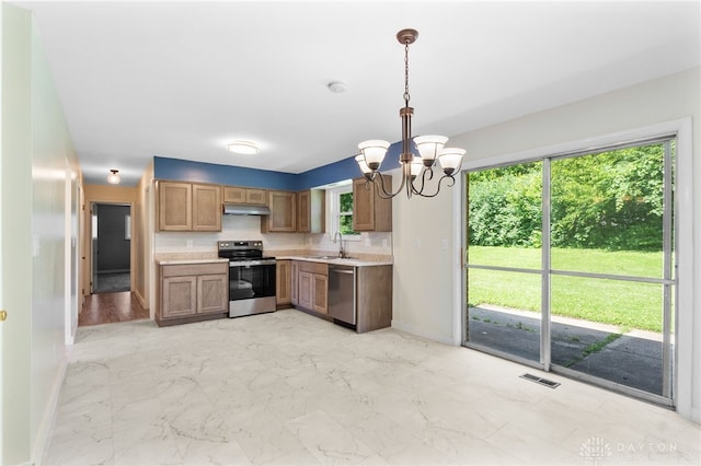 925 Robinette Ave, Vandalia, OH 45377 - kitchen featuring stainless steel appliances, light countertops, a chandelier, and plenty of natural light