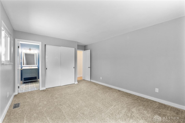 925 Robinette Ave, Vandalia, OH 45377 - unfurnished bedroom featuring carpet floors, ensuite bath, and a closet