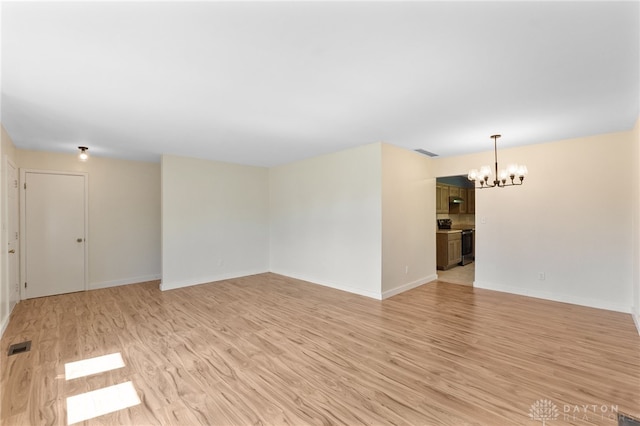 925 Robinette Ave, Vandalia, OH 45377 - spare room featuring a chandelier and light wood-style floors