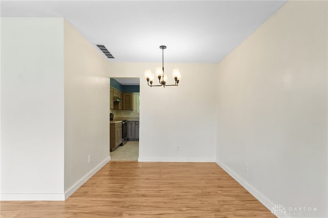 925 Robinette Ave, Vandalia, OH 45377 - unfurnished dining area featuring a chandelier and light wood-style floors